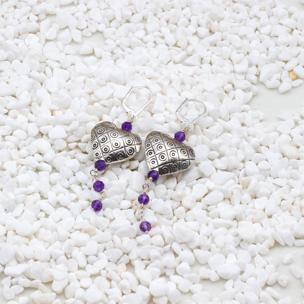 Sterling silver hearts intertwine with exquisite amethyst gemstones, evoking the richness and allure of fine wine.