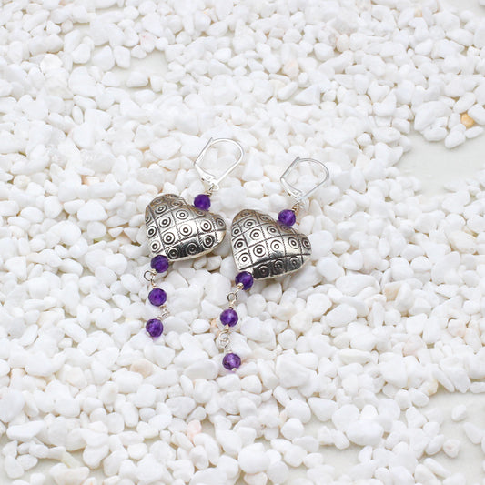Sterling silver hearts intertwine with exquisite amethyst gemstones, evoking the richness and allure of fine wine.