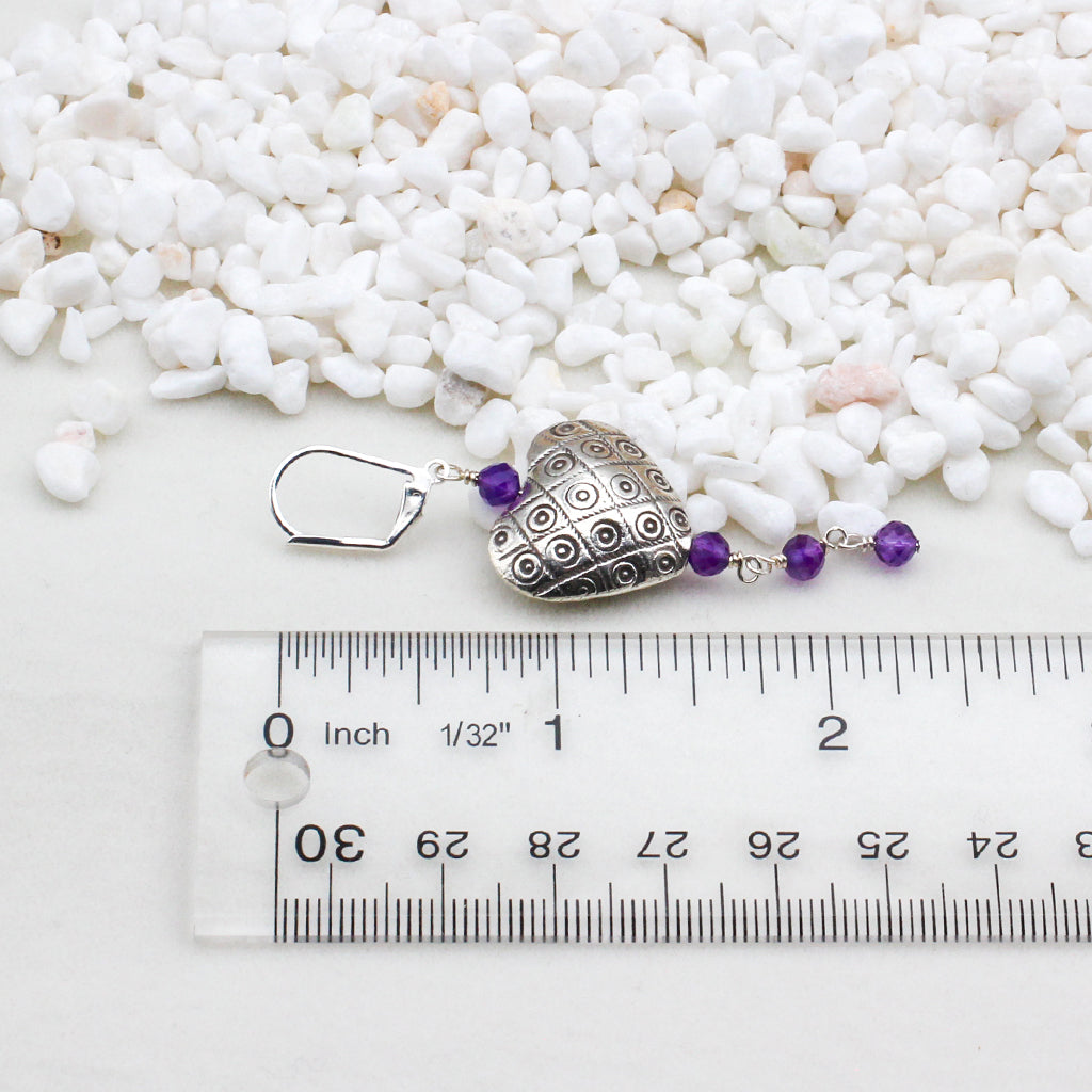 Sterling silver hearts intertwine with exquisite amethyst gemstones, evoking the richness and allure of fine wine.