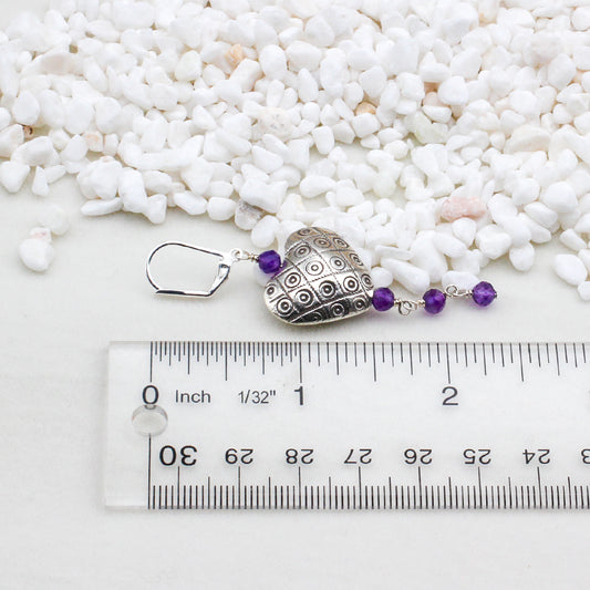 Sterling silver hearts intertwine with exquisite amethyst gemstones, evoking the richness and allure of fine wine.
