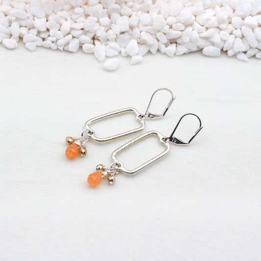 Silver etched rectangular centerpiece embellished with delicate Melon Jade Briolette's and Crystals, all elegantly hanging from secure lever-back ear wires.