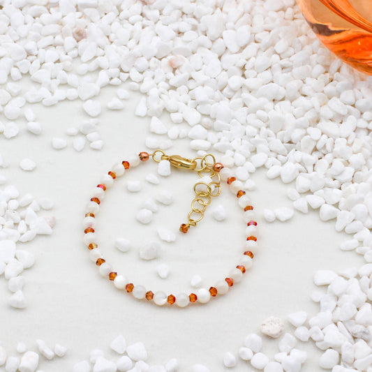 Bracelet of Crystal Beads paired with lustrous Mother-of-Pearl gemstones, expertly crafted with gold electroplated brass metals.