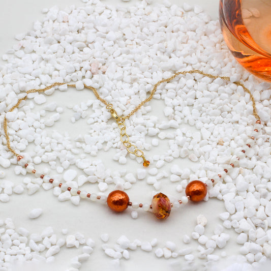 Mother-of-Pearl gemstones, faceted crystals with gold electroplated metals. A delicate Singapore Curb Chain with a Lobster Clasp closure.