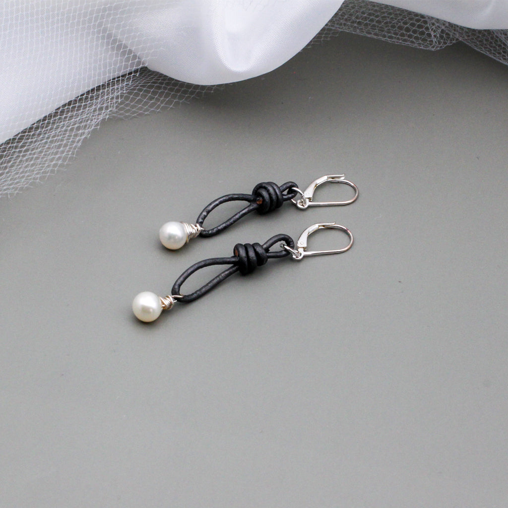 Gray leather is accented with hand wrapped white Freshwater Pearl drop beads. Finished with silver lever-back ear-wires.
