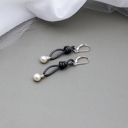 Gray leather is accented with hand wrapped white Freshwater Pearl drop beads. Finished with silver lever-back ear-wires.