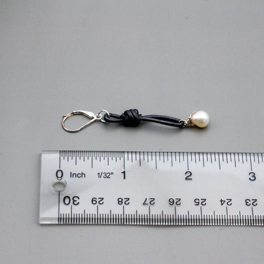 Gray leather is accented with hand wrapped white Freshwater Pearl drop beads. Finished with silver lever-back ear-wires.