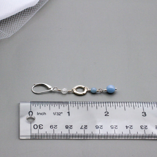 Angelite Gemstones and iridescent rainbow Moonstone beads, accented by a textured sterling silver ring link. The lever-back ear-wires ensure a secure and comfortable fit.