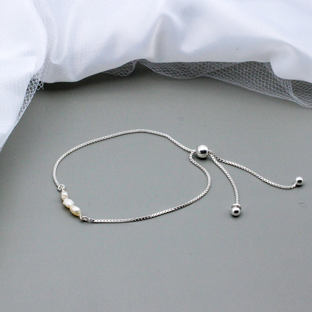 Freshwater pearls delicately arranged on an adjustable silver plated bracelet base.