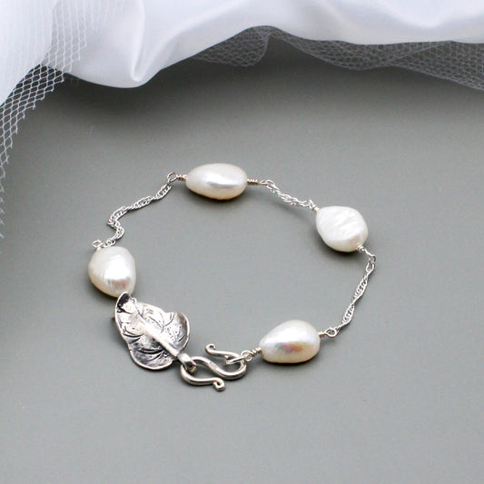 Crafted with stunning freshwater pearls, adorned by a Sterling Silver Leaf clasp and hung on a Sterling Silver chain.