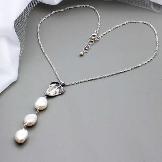 Three large freshwater pearls as centerpiece features a sterling silver leaf focal, a sterling silver lobster claw clasp ensures a secure and stylish closure.
