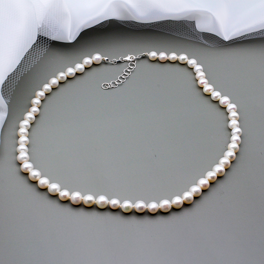 This beautiful classic necklace features a stunning strand of freshwater pearls. The piece is completed with a Sterling Silver lobster clasp closure and chain extender.