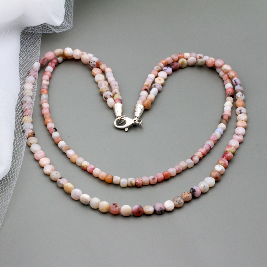 Double strand necklace is crafted with faceted pink opal gemstone beads and sterling silver findings.
