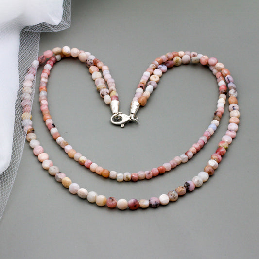 Double strand necklace is crafted with faceted pink opal gemstone beads and sterling silver findings.