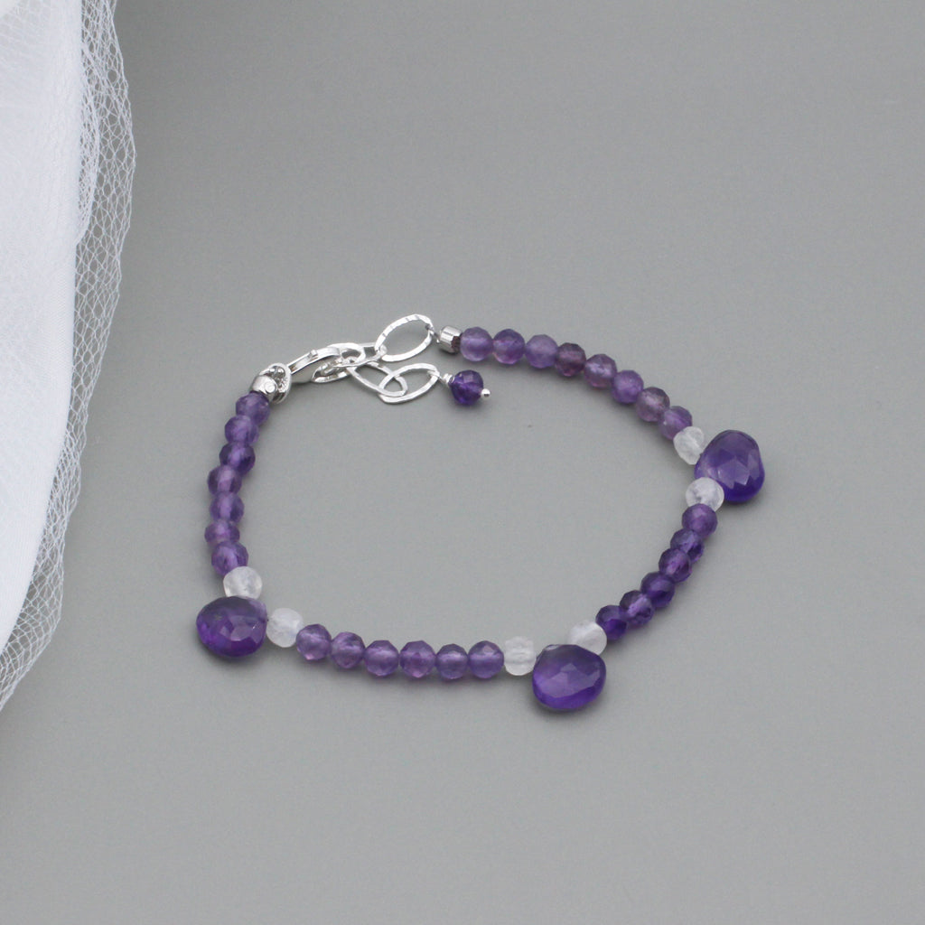 Amethyst and Moonstone gemstones, including 3 Amethyst Briolette's. The Sterling Silver Lobster clasp with a 2-inch extender chain.