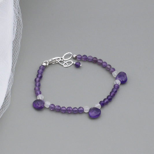 Amethyst and Moonstone gemstones, including 3 Amethyst Briolette's. The Sterling Silver Lobster clasp with a 2-inch extender chain.