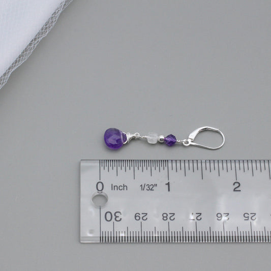 Handcrafted elegance, these earrings feature a graceful combination of Moonstone and Amethyst Briolette, suspended from a Sterling Silver lever-back ear-wire.