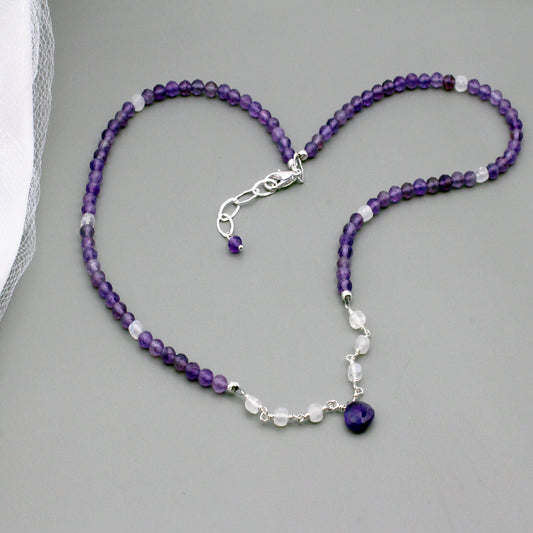 Beautiful Amethyst and Moonstone gemstones featuring a delicate central focal point. The Sterling Silver Lobster clasp is paired with a 2-inch extender chain.