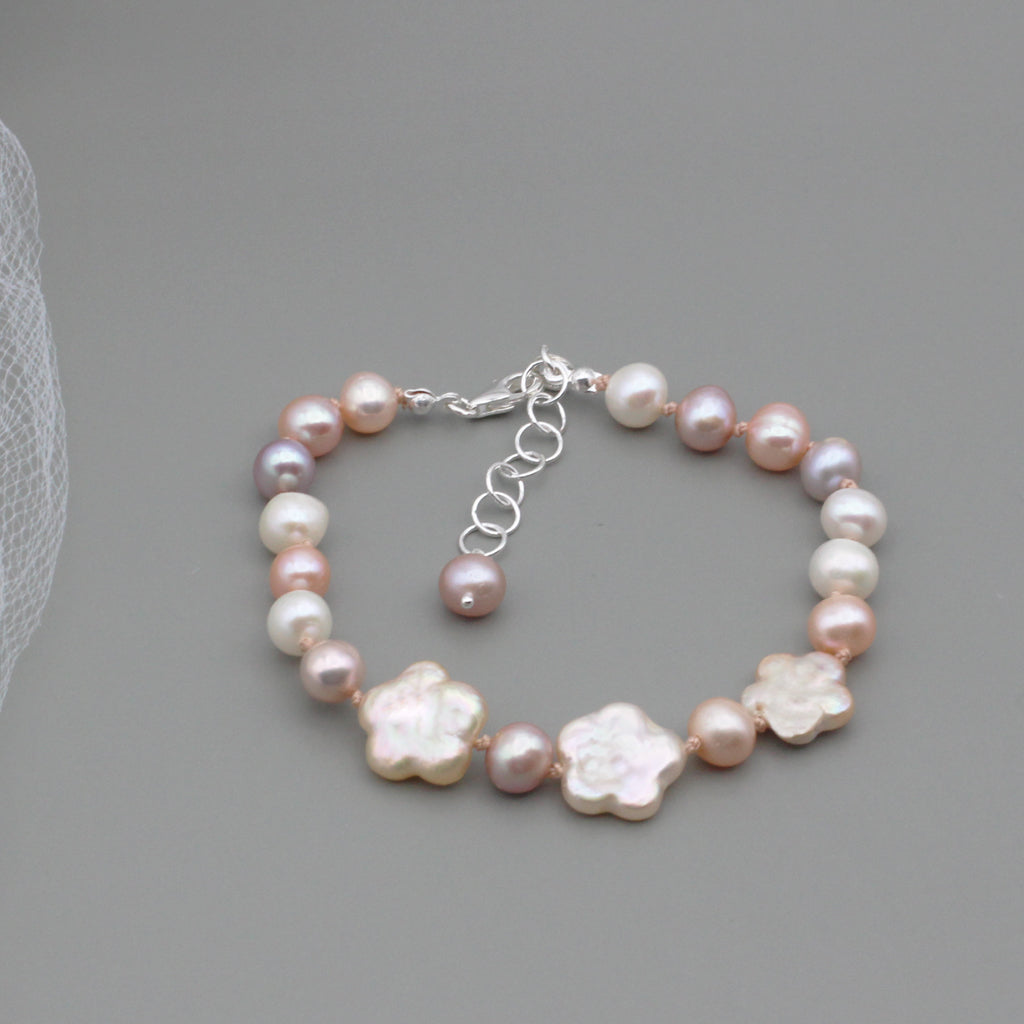 Bracelet showcases a beautiful combination of circular and detailed botanical freshwater pearls, The Sterling Silver Lobster clasp is fastened with a 2inch extender chain for enhanced flexibility.