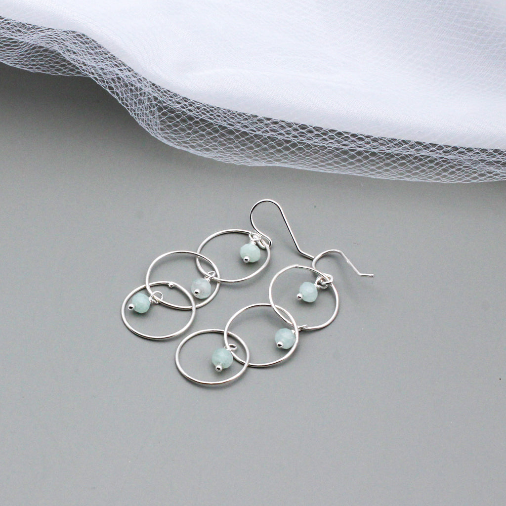 Handcrafted with Sterling Silver and Aquamarine Gemstones. Designed with three elegant loops and a delicate fish-hook ear-wires.