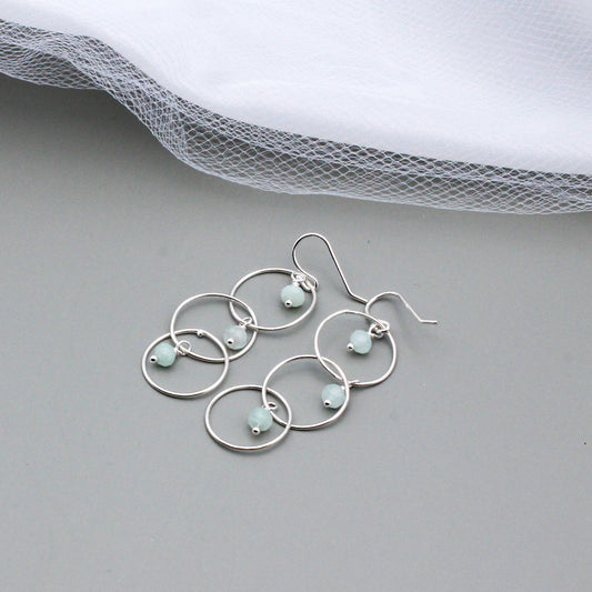 Handcrafted with Sterling Silver and Aquamarine Gemstones. Designed with three elegant loops and a delicate fish-hook ear-wires.