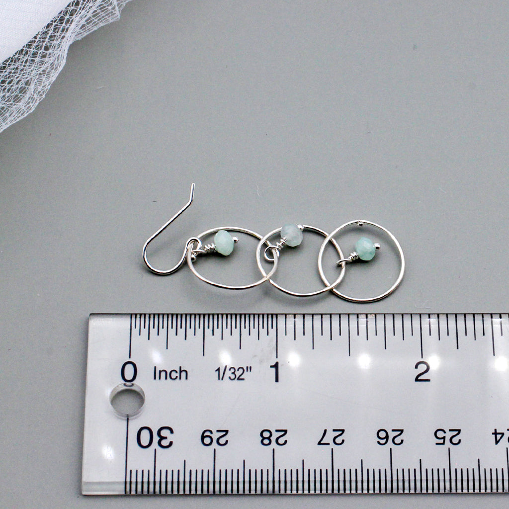 Handcrafted with Sterling Silver and Aquamarine Gemstones. Designed with three elegant loops and a delicate fish-hook ear-wires.