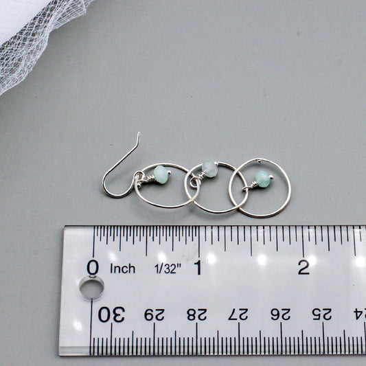 Handcrafted with Sterling Silver and Aquamarine Gemstones. Designed with three elegant loops and a delicate fish-hook ear-wires.