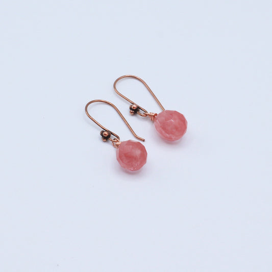 Earrings feature an antique copper fish-hook wire paired with a faceted cherry quartz teardrop.