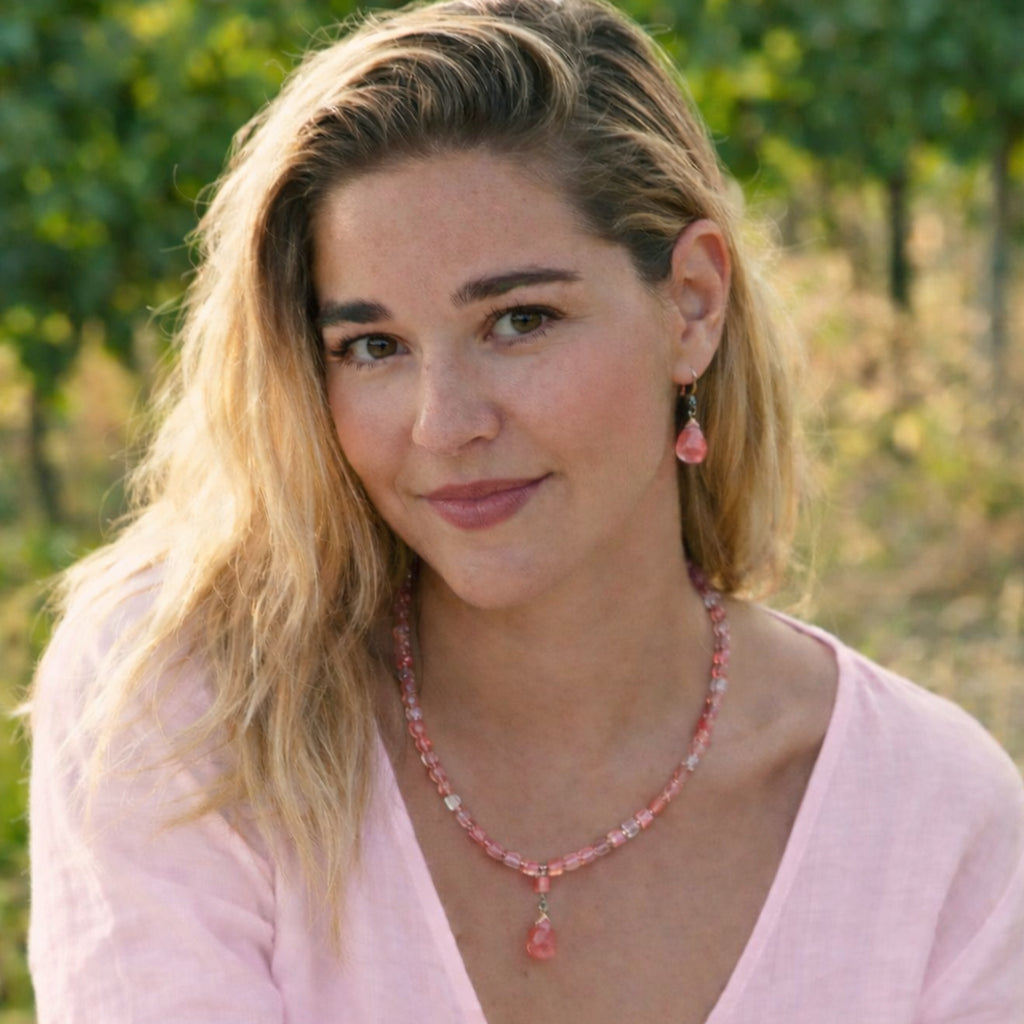 Necklace of warm antique copper with luminous cherry quartz gemstones and crystal accents.