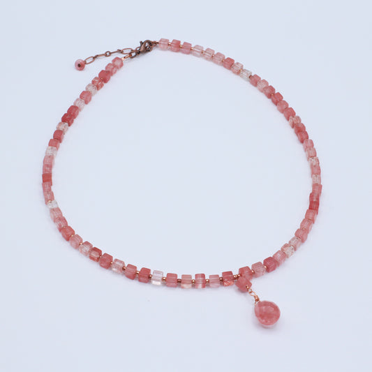 Necklace of warm antique copper with luminous cherry quartz gemstones and crystal accents.