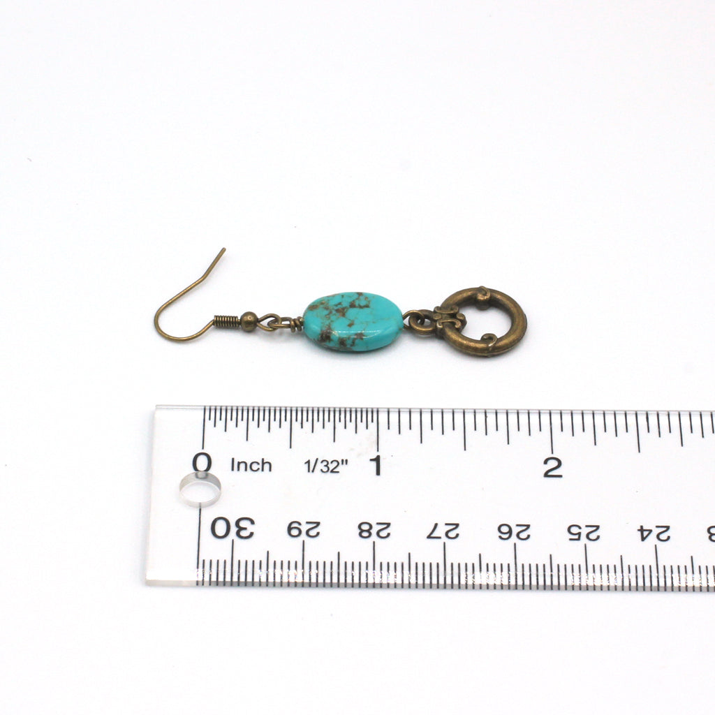 Turquoise and bronze earrings on a white background.