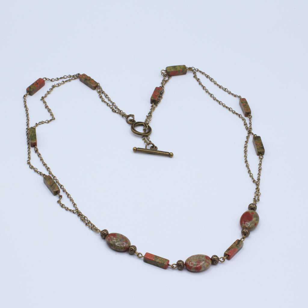 Necklace features a dual-chain design in antique bronze, anchored by striking Jasper brick and oval gemstones