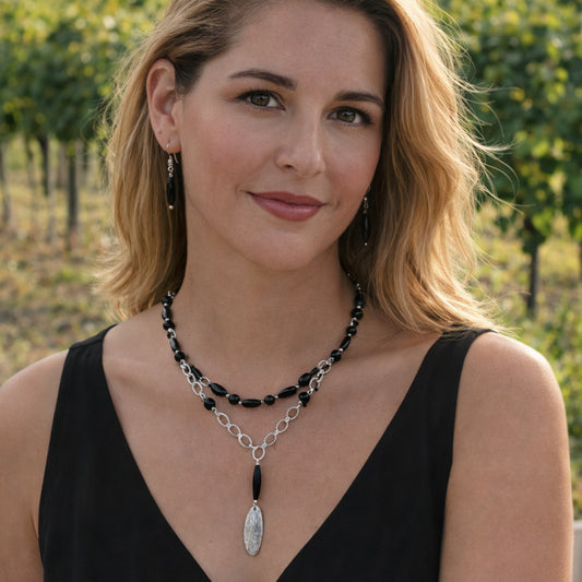 Riftline necklace pairs dark gemstones—obsidian, hematite, and onyx—with silver electroplated brass chain.