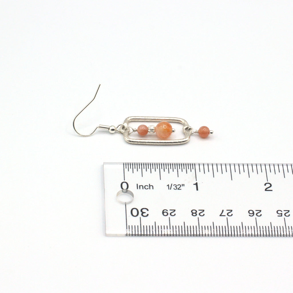 Earrings adorned with warm sunstone gemstones. Suspended from delicate fishhook earwires.