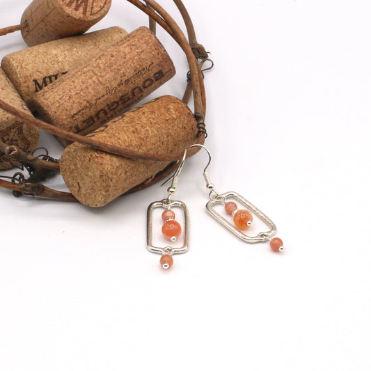 Earrings adorned with warm sunstone gemstones. Suspended from delicate fishhook earwires.