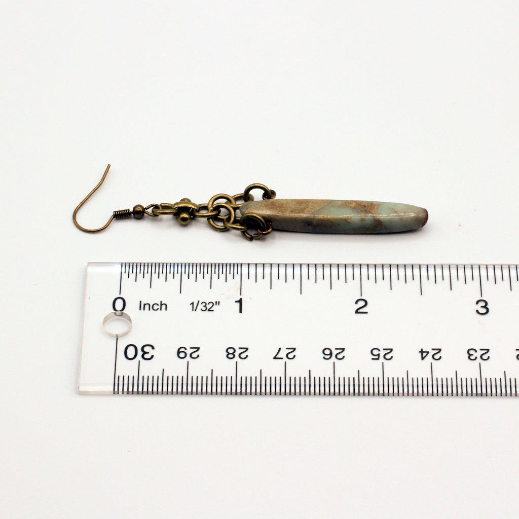 Bold earrings featuring Bumble Bee Jasper Dagger Gemstones paired with a distinctive antique bronze chain for a dynamic dangle effect.