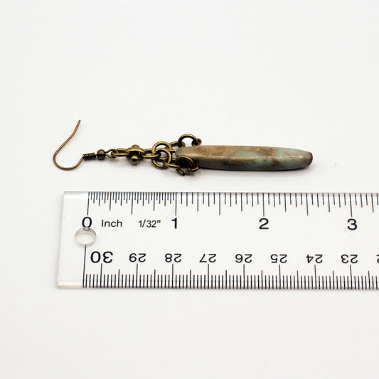 Bold earrings featuring Bumble Bee Jasper Dagger Gemstones paired with a distinctive antique bronze chain for a dynamic dangle effect.