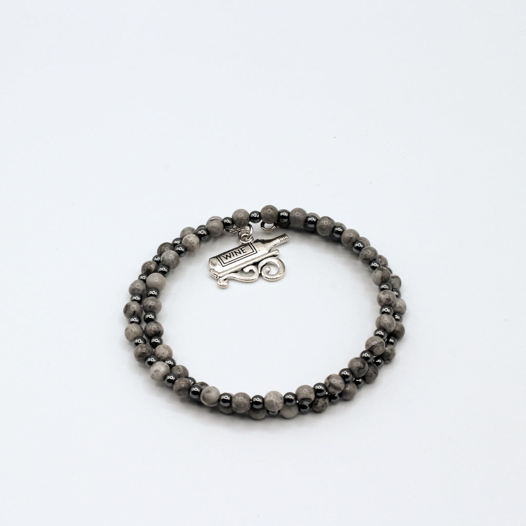 This double memory wire bracelet showcases a cute "wine bottle" charm, making it an ideal accessory for celebrating special moments