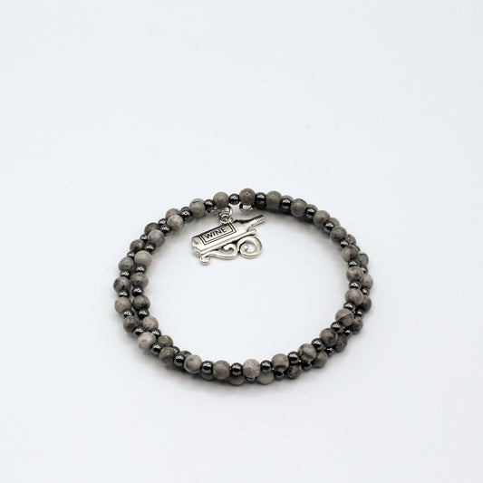 This double memory wire bracelet showcases a cute "wine bottle" charm, making it an ideal accessory for celebrating special moments