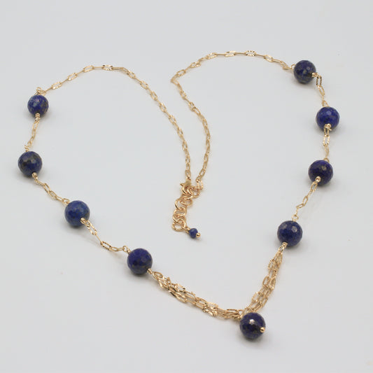 The Sol Lazuli Necklace features radiant Lapis Lazuli stones set against a delicately textured paperclip chain. 