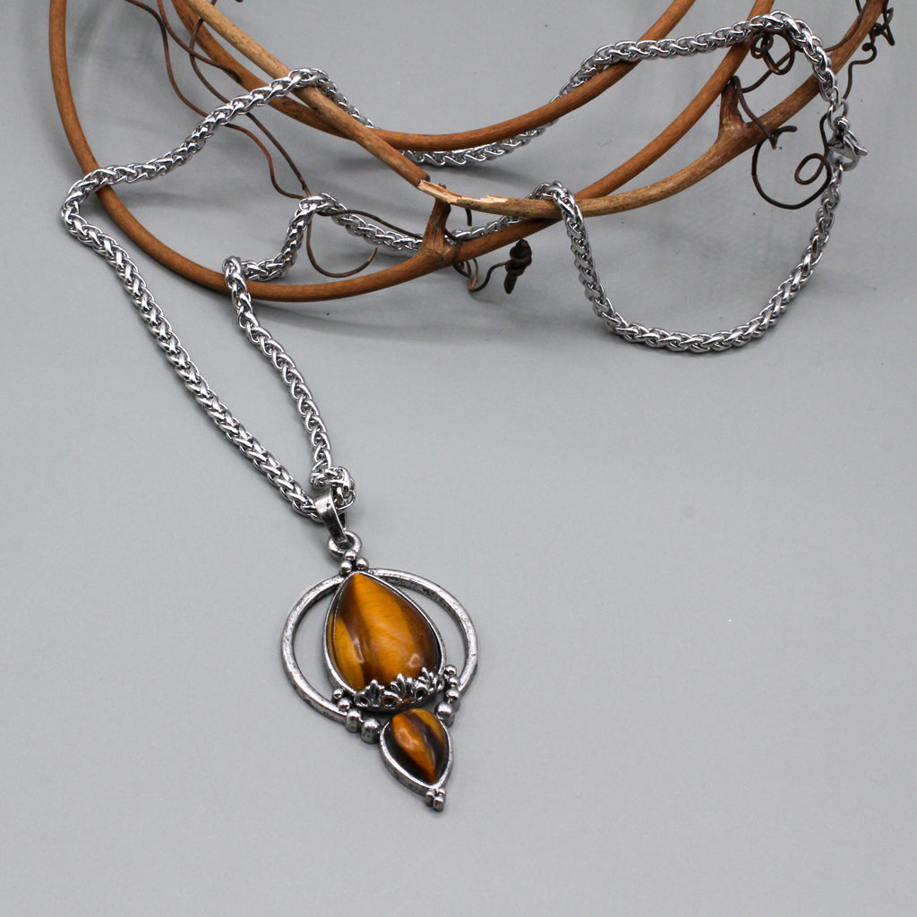 Teardrop tiger-eye gemstone pendant, encased in finely crafted silver electroplated brass.  Hanging from a stainless steel rope chain.