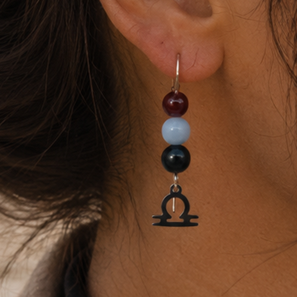 Celebrate the graceful spirit of Libra with earrings featuring Obsidian, Angelite, and Garnet—a distinctive gemstone trio symbolizing balance, peace, and passion.Finished with a Libra symbolic charm and suspended from a hand-forged earwire.