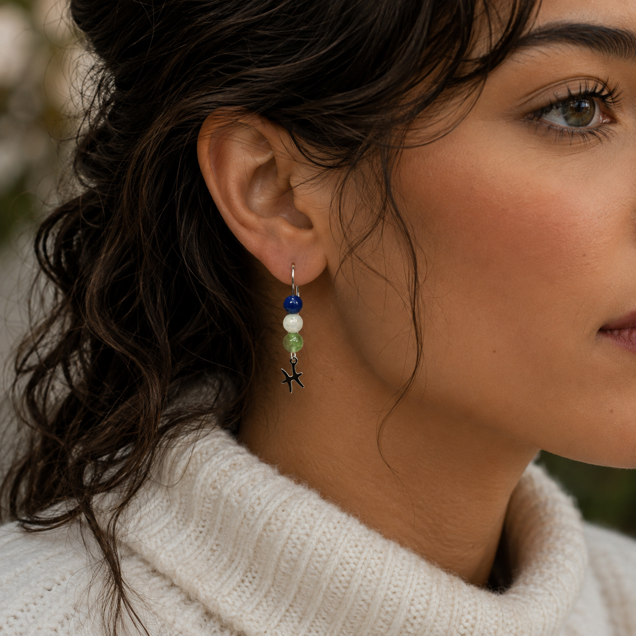Celebrate the dreamy spirit of Pisces with earrings featuring Peridot, Moonstone, and Lapis Lazuli—a gemstone trio representing renewal, intuition, and inner wisdom. Finished with a Pisces symbolic charm and suspended from a hand-forged earwire.