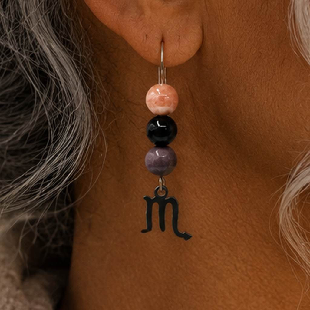 Embrace the captivating spirit of Scorpio with earrings featuring Rhodonite, Onyx, and Sunstone—a gemstone trio representing heart, strength, and transformation. Finished with a Scorpio symbolic charm and suspended from a hand-forged earwire.