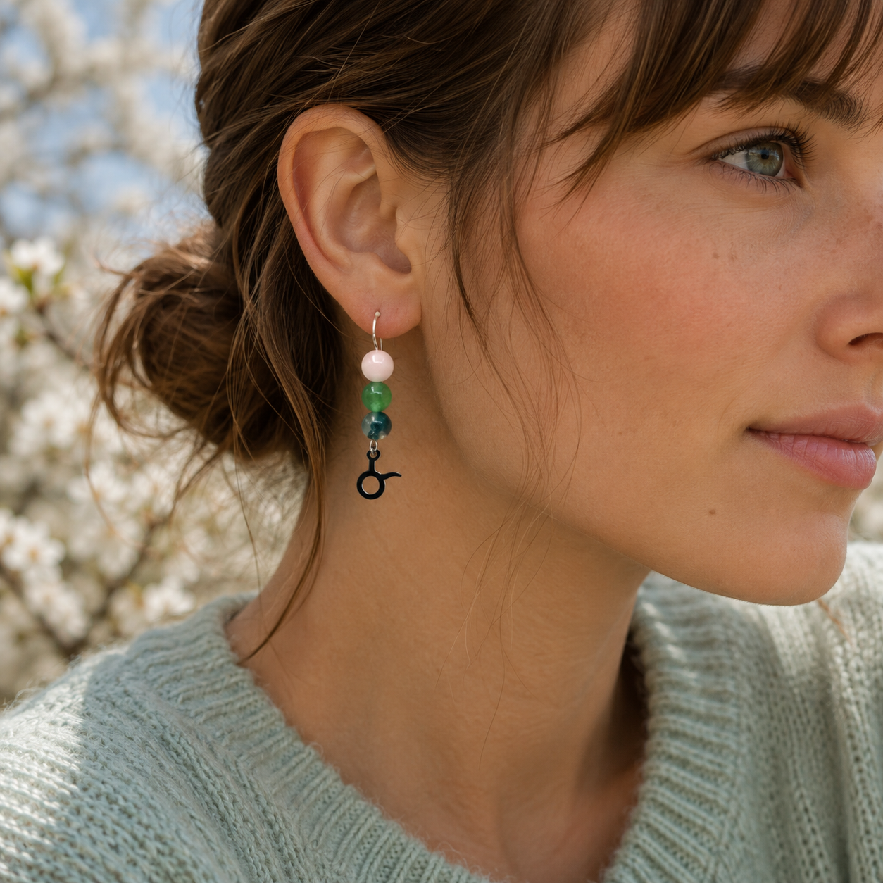 Celebrate the grounded beauty of Taurus with earrings featuring Moss Agate, Aventurine, and Rose Quartz—a gemstone trio representing growth, abundance, and love.Finished with a Taurus symbolic charm and suspended from a hand-forged earwire.