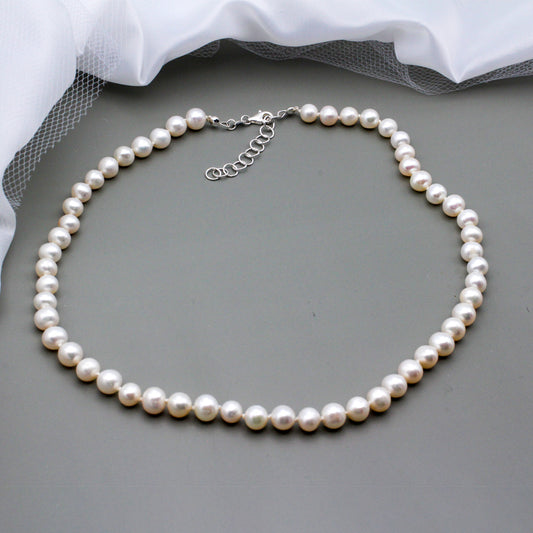 This beautiful classic necklace features a stunning strand of freshwater pearls. The piece is completed with a Sterling Silver lobster clasp closure and chain extender.