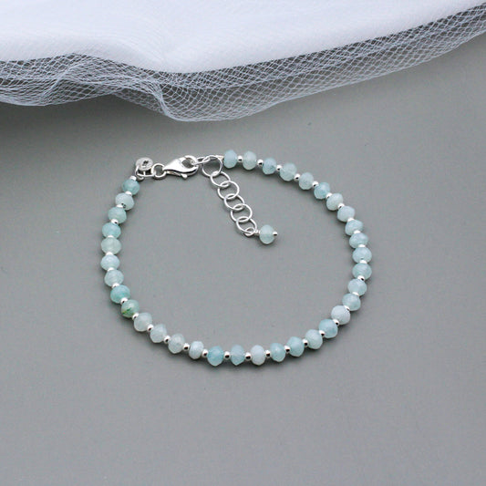 Aquamarine Gemstones set against the sleek backdrop of sterling silver metals. This expertly crafted piece offers a subtle yet sophisticated elegance.
